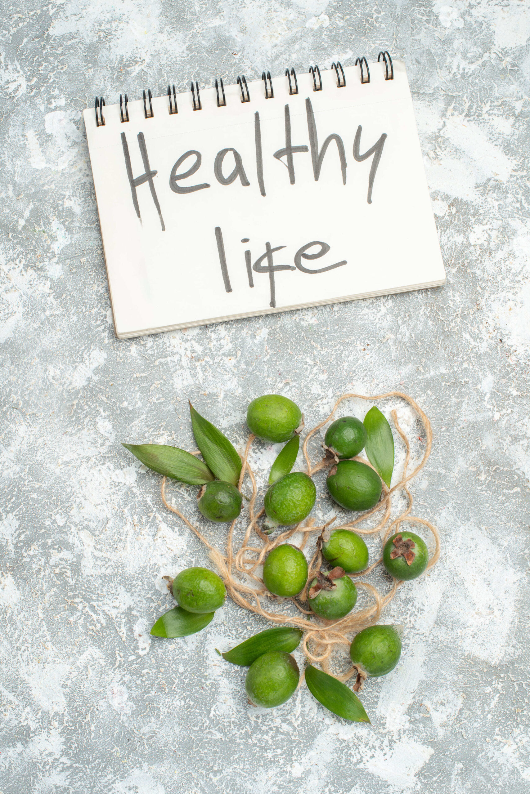 top-view-fresh-feykhoas-healthy-life-written-notebook-grey-surface-free-space